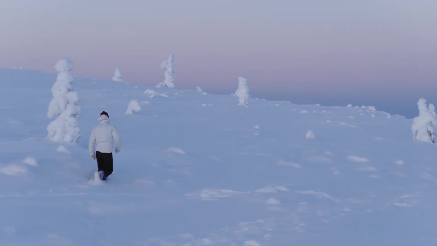 The man hiking trips while walking through the deep snow