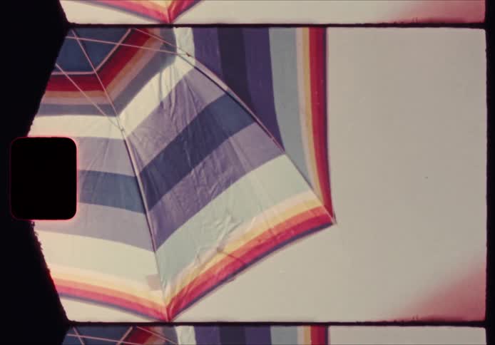 Striped beach umbrella seen from below against the sky