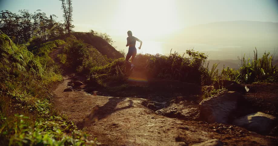 A woman running on a trail