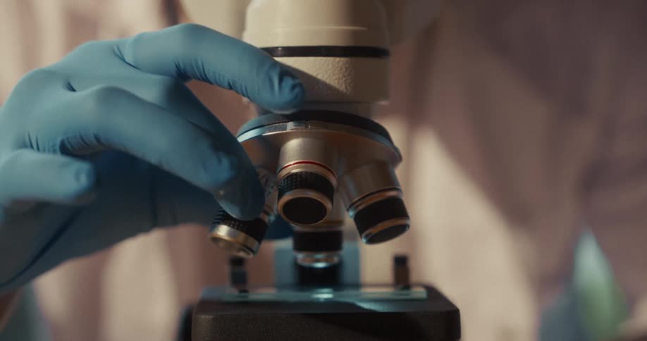 Lab technician works with a microscope