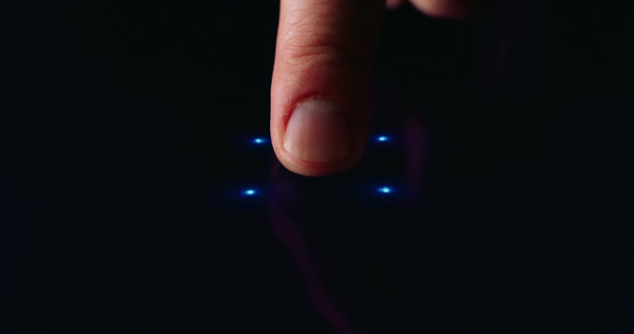 A finger touches a dark surface triggering a blue digital holographic interface