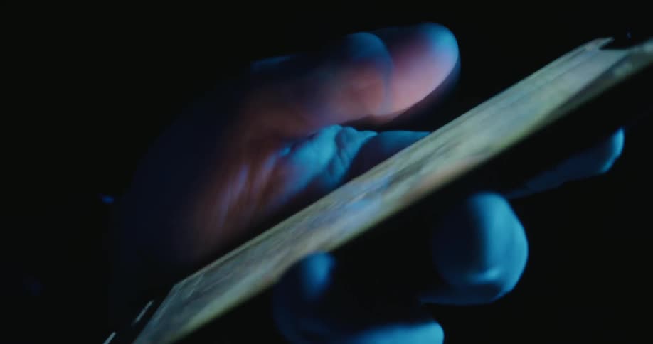 Hand holding a smartphone while a finger interacts with the screen