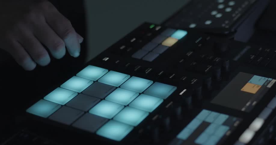 Hand touching illuminated pads on an electronic music controller