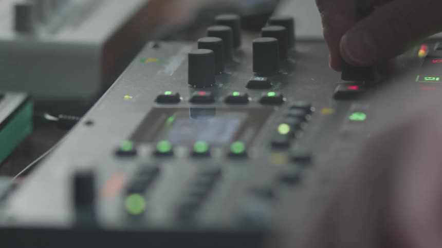 Adult hands adjust knobs on an electronics board