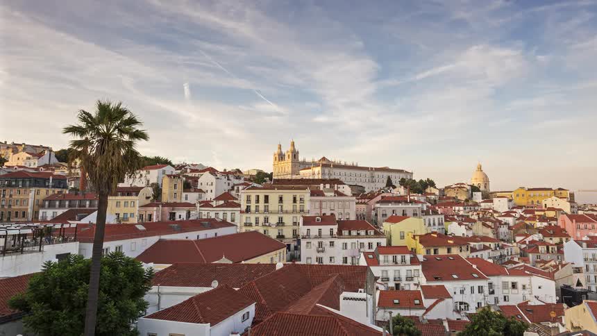 Houses in a neighborhood are all the same color with red roofs