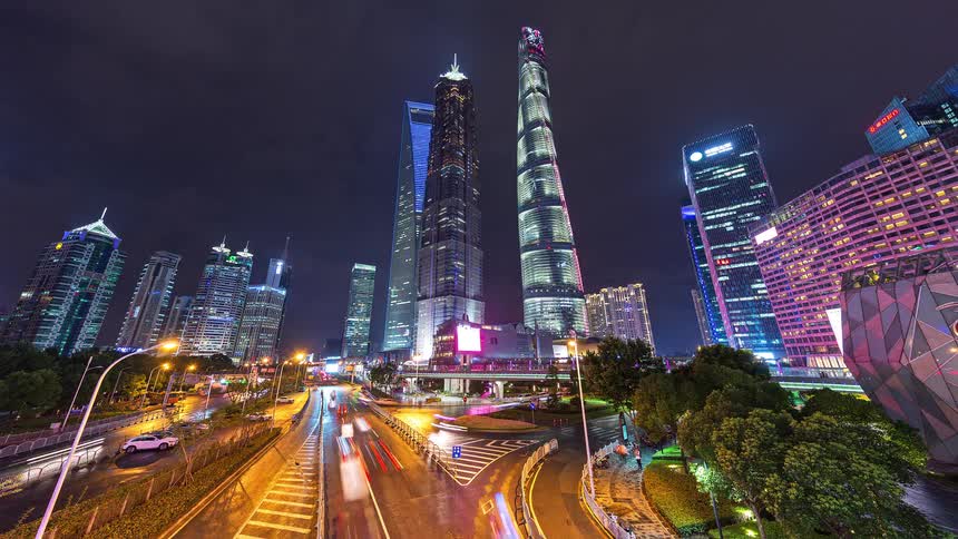Heavy traffic flows in and out of a city at night