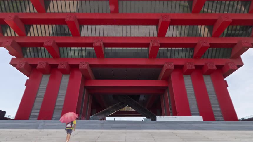 The china art museum in shanghai featuring its distinctive red inverted pyramid architectural structure