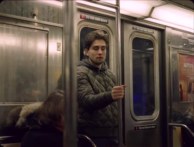 Man standing inside a moving train