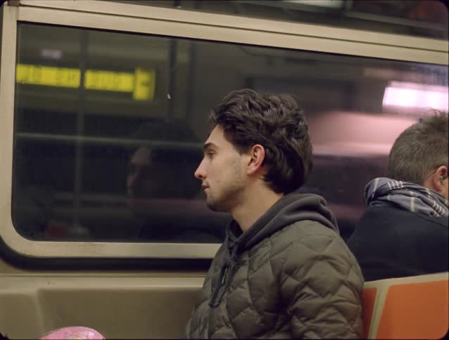 Man sitting inside a moving train