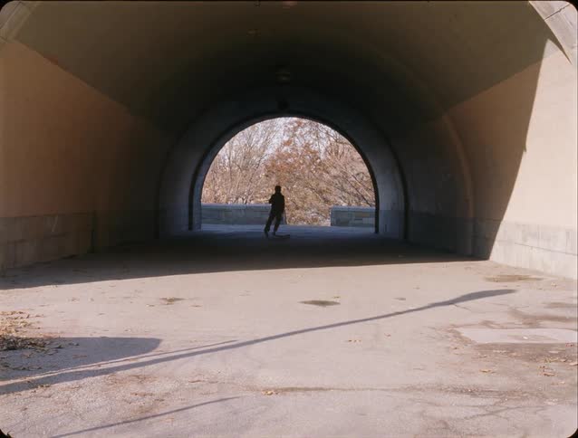 Man skateboarding in a tunnel