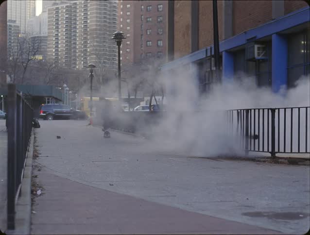A man skateboarding on a sidewalk in a city