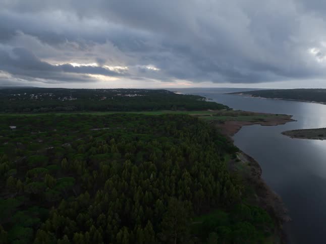 Aerial time lapse of the landscape around a large river on a cloudy day