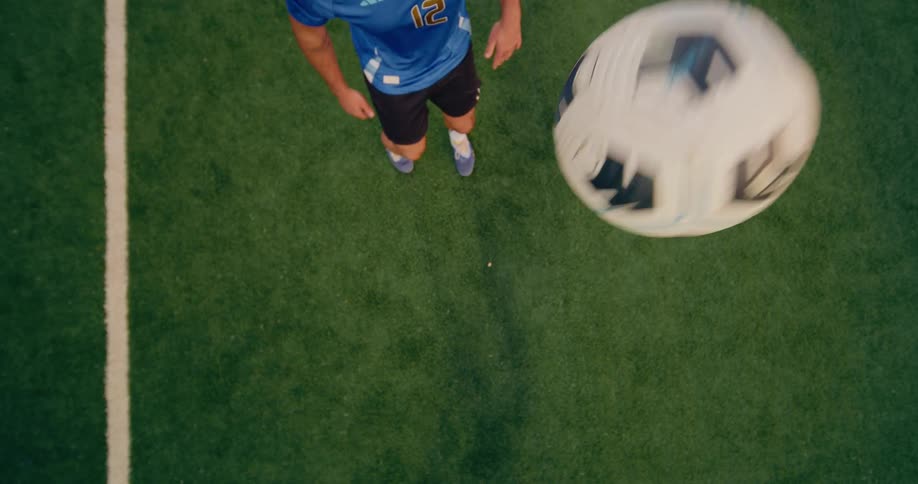 A man kicking a soccer ball into the air