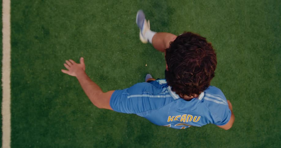 This video shows a topdown perspective of a person practicing soccer skills on a green turf field the individual wearing a blue jersey with the name keanu and the number 17 is seen juggling a soccer ball with their feet and knees