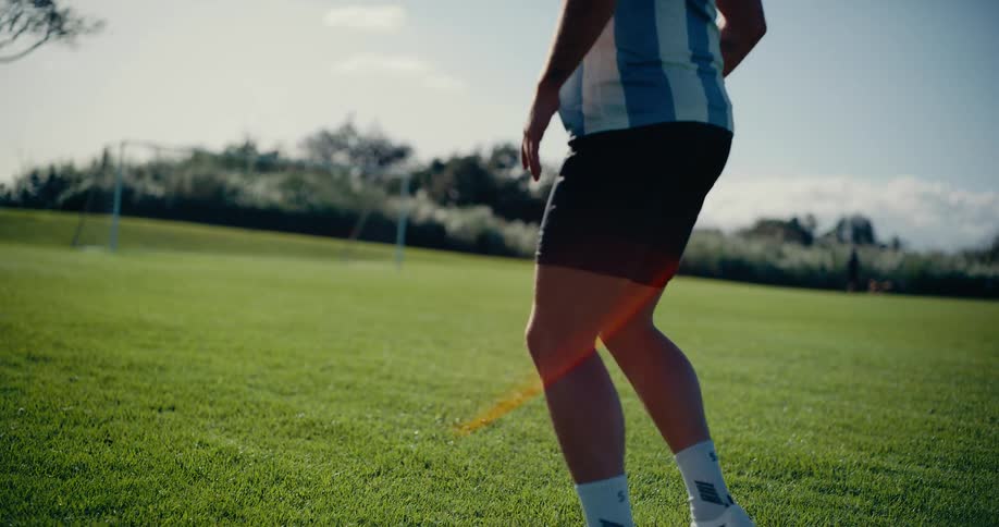 Two young men pass a soccer ball back and forth to each other