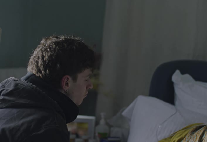 A man talking to a sick woman in a hospital
