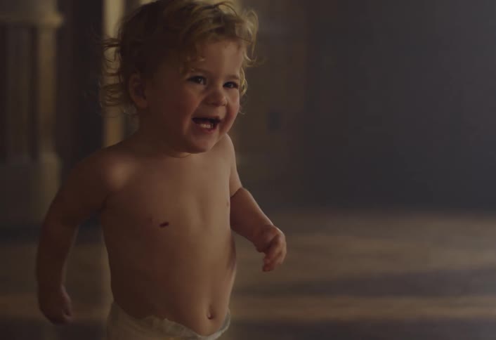 Smiling little child running around the room in an indoor setting