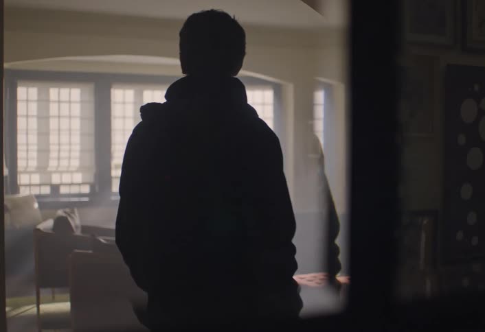 A man walking around in a room thinking