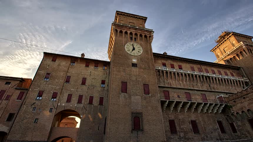 A clock is up ona tower on an ancient castle building