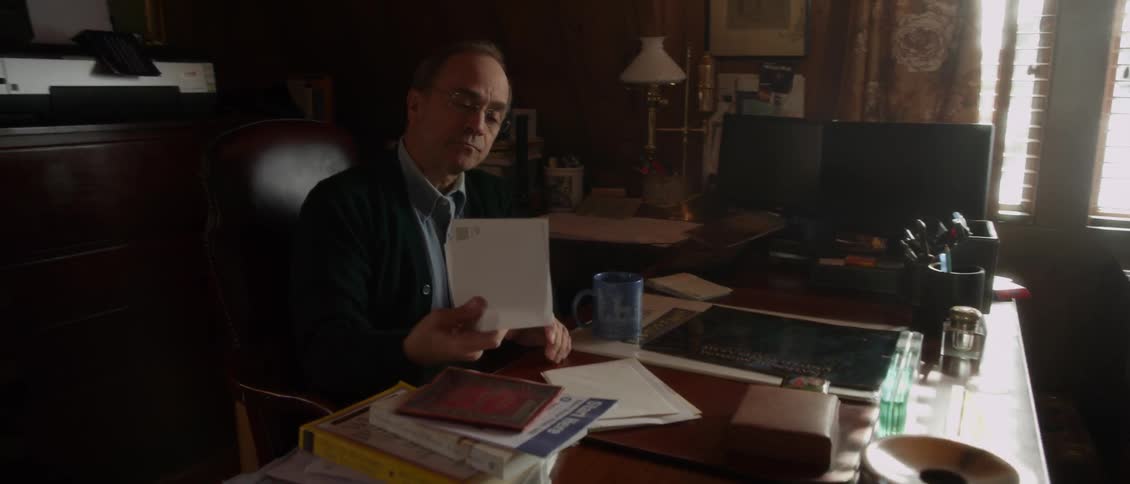 A man sorts through papers at a desk
