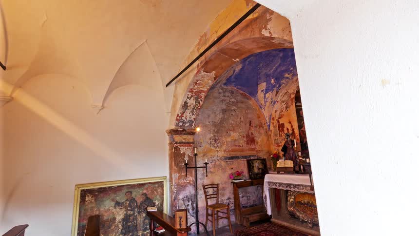 Entrance inside a building with an altar and painting on the wall