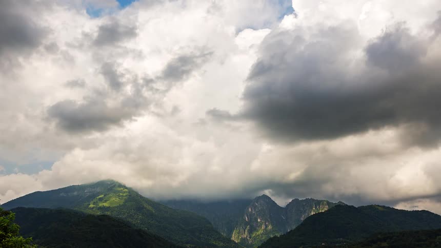 Heavy clouds fill the sky above hazy mountains
