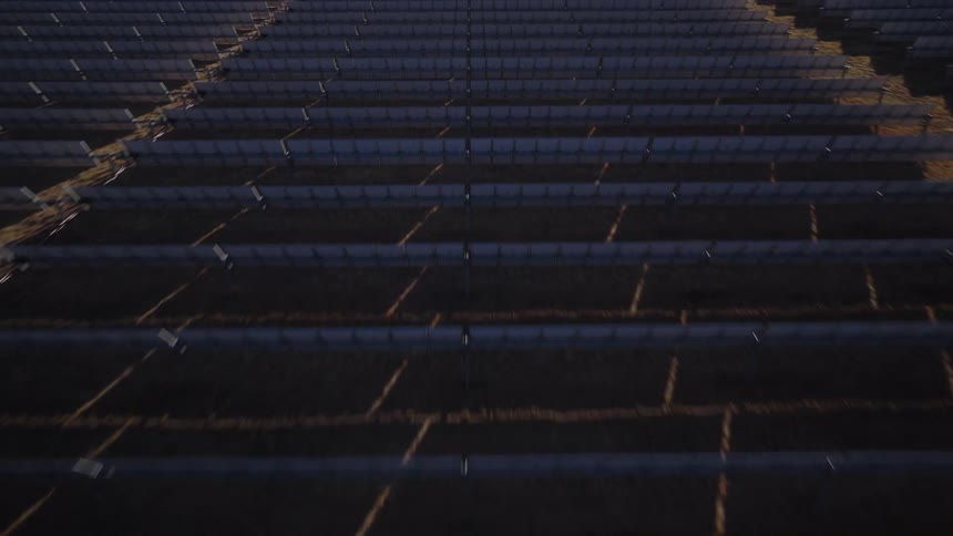 Solar panels are set up in an dirt field