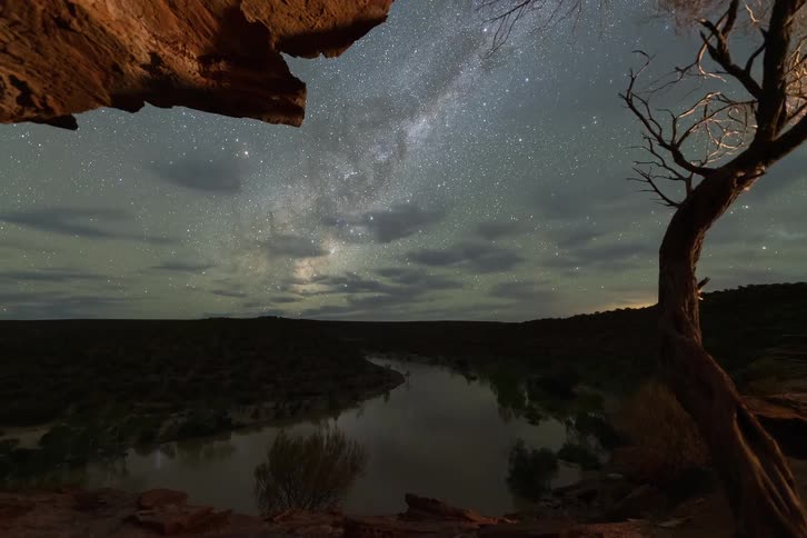 A landscape view with stars above it at night