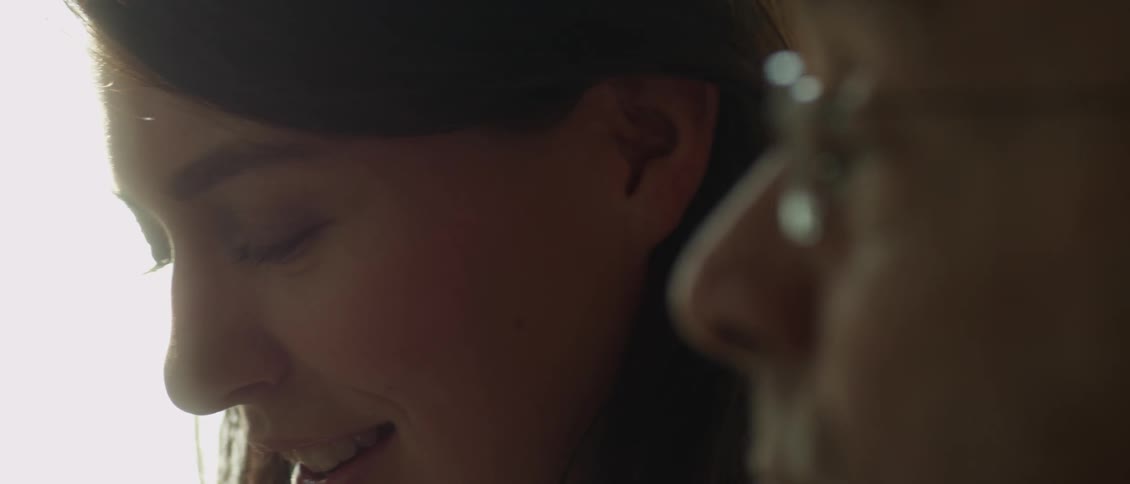 A man and woman talk and smile together