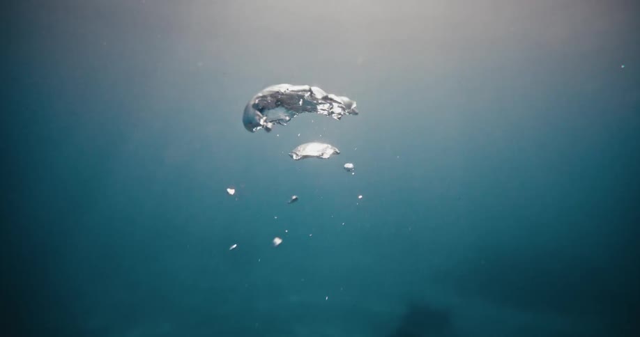 Air mass rises through the murky water from the seafloor releasing bubbles