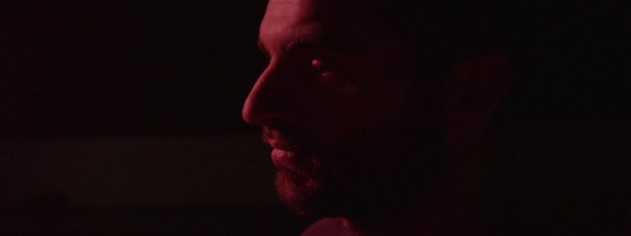 A man solemnly stares straight ahead
