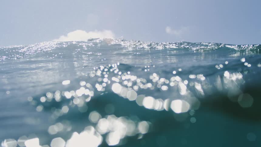 Ocean surface with bright sunlight reflections on the waves