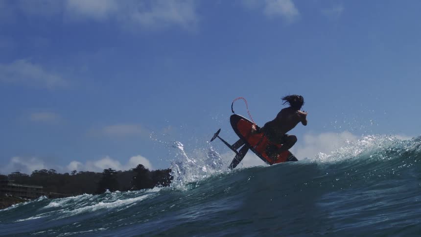 A person surfing on a large wave on the ocean