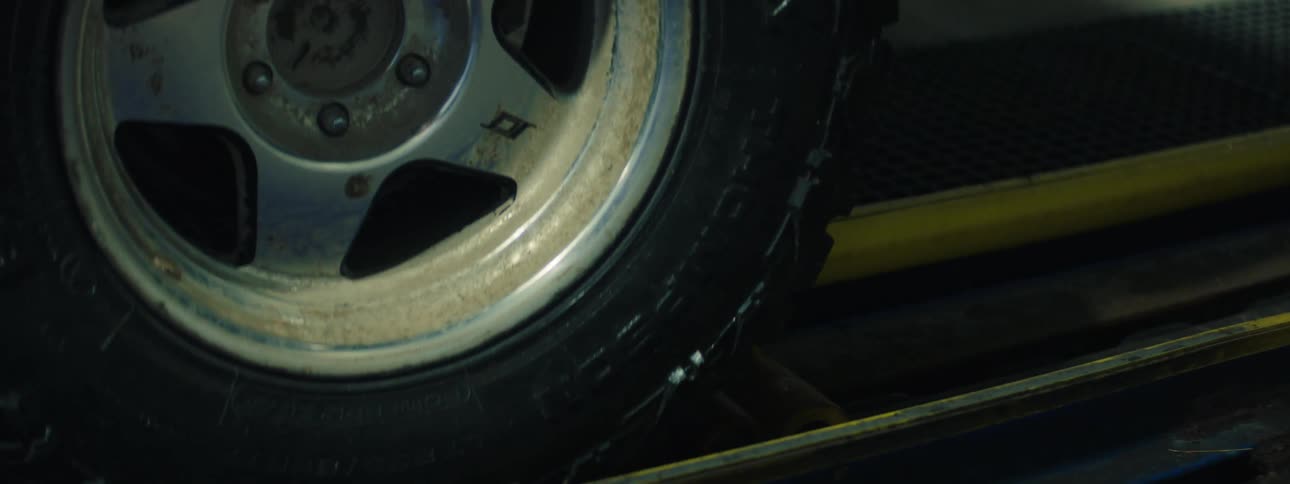 Vehicle wheel positioned on a guide rail in an automatic car wash system