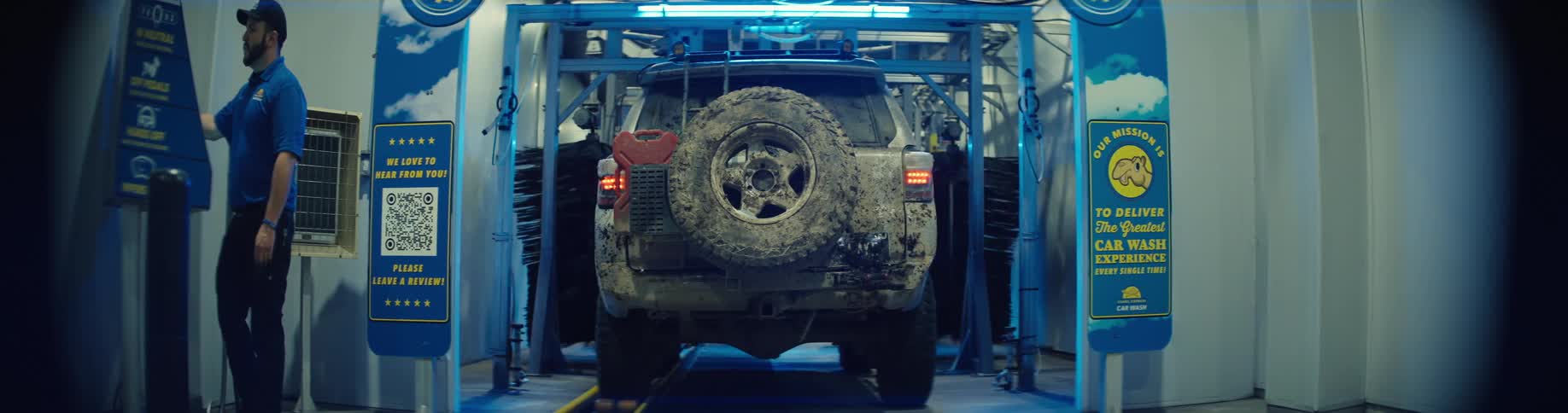 Mudcovered vehicle entering automated car wash
