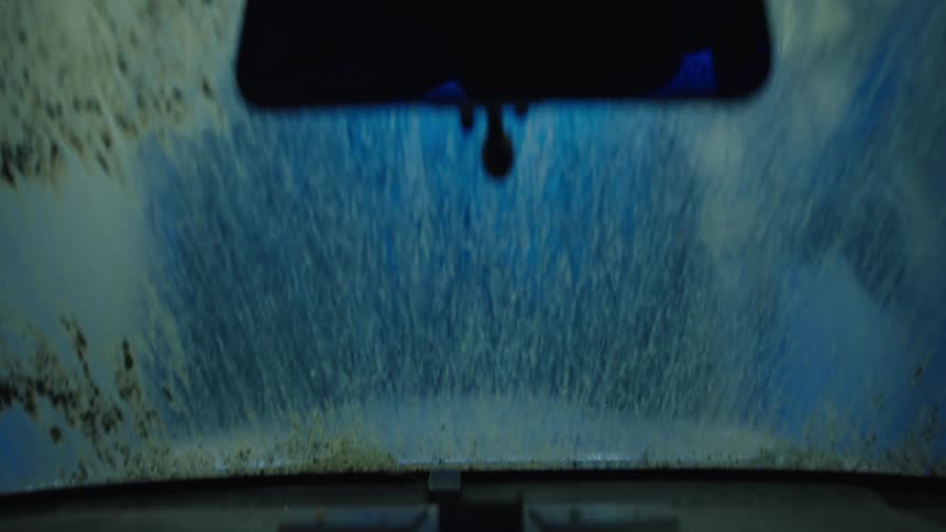 The car is being cleaned in the car wash