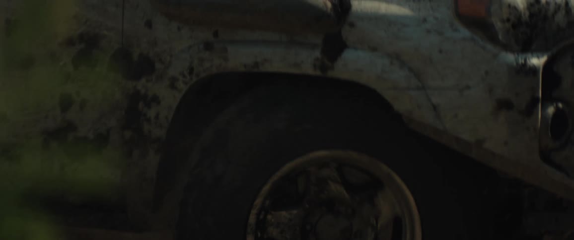 Truck traveling on a dirt road through the woods