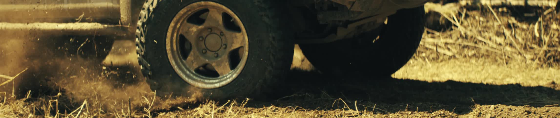 A car driving outdoors on a dirt road