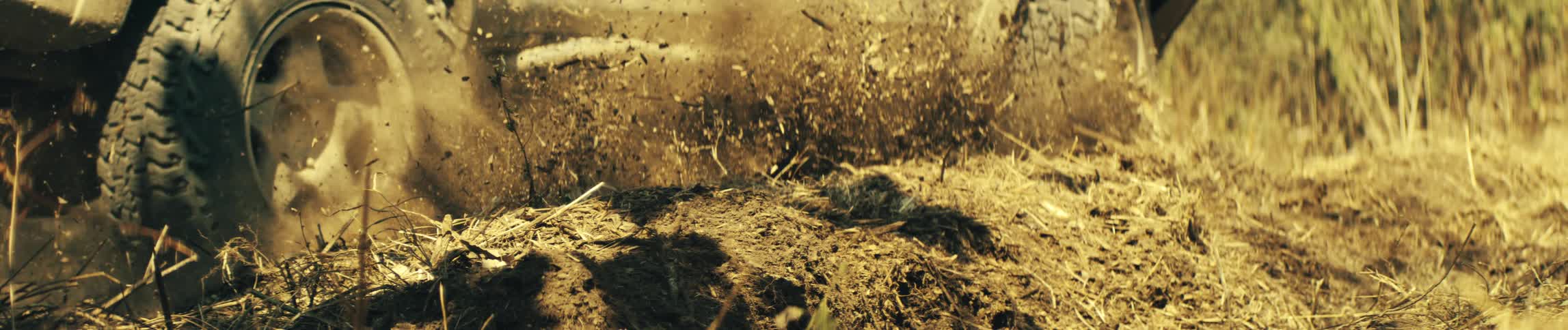 A car driving outdoors in the dirt