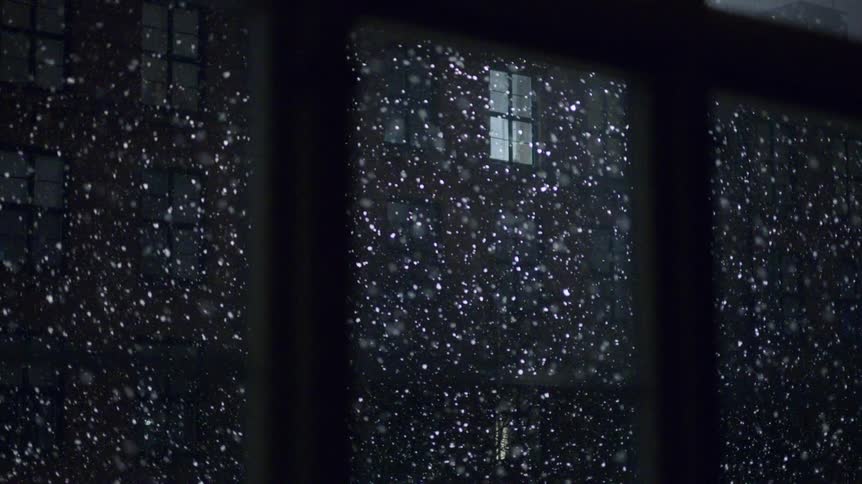 A view of snow falling from a window
