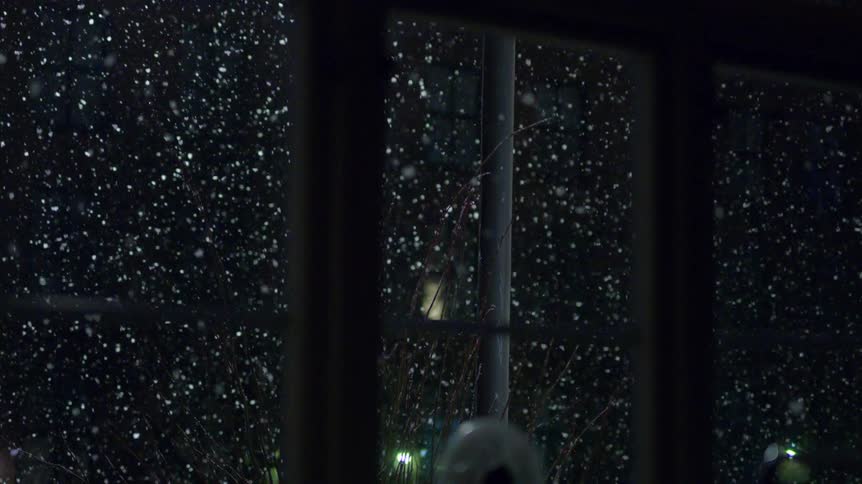 Snow is falling outside the window