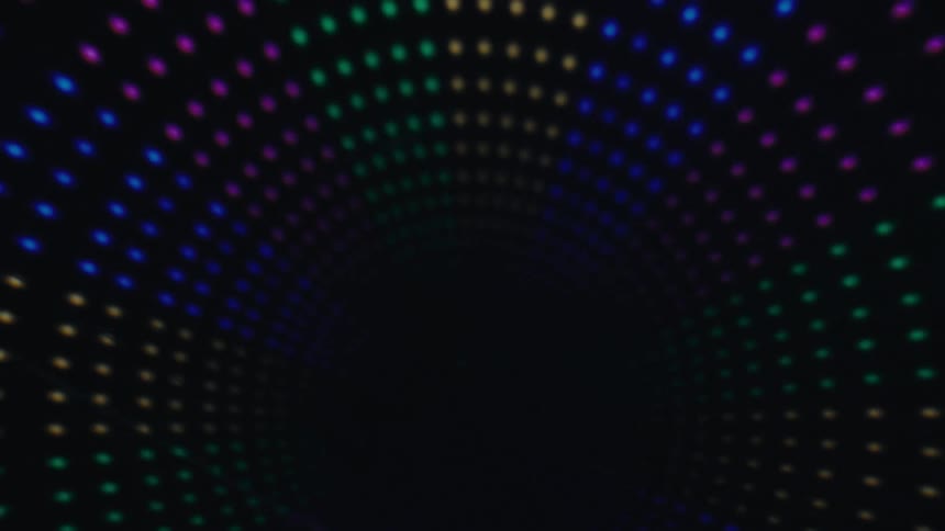 Colorful led lights form a glowing tunnel pattern that fades into darkness at the center