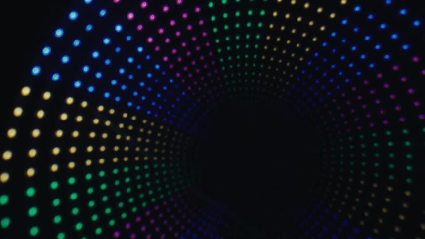 Circular pattern formed by colored luminous dots on a dark background