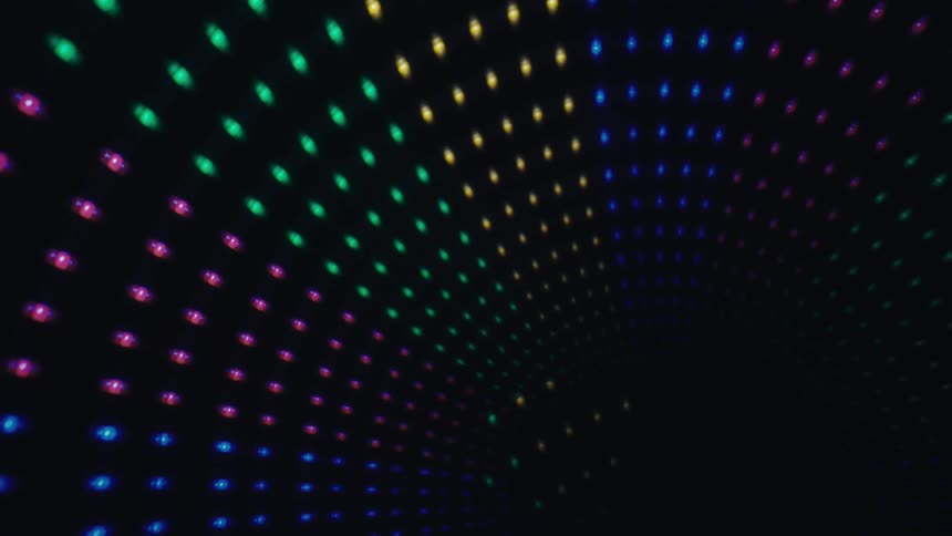 Colored luminous dots form a curved pattern on a dark background