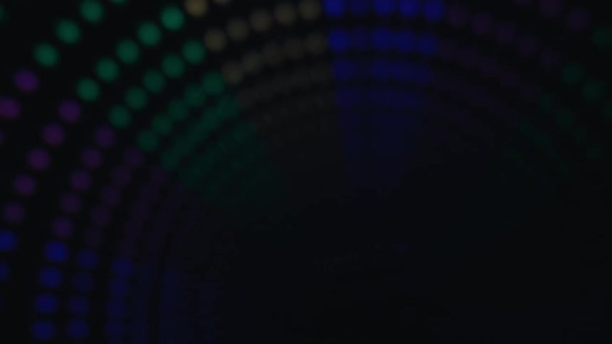 Curved lines of glowing colored lights in the darkness
