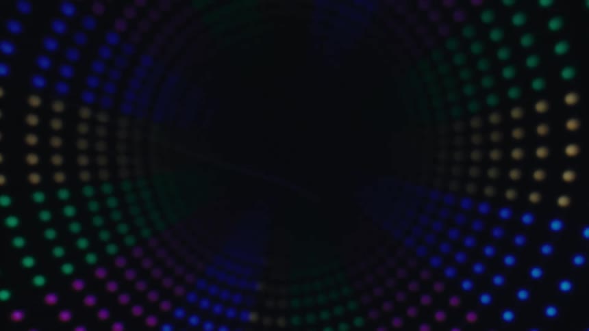 A colorful array of blurred circular lights forms a receding circular tunnel against a dark background