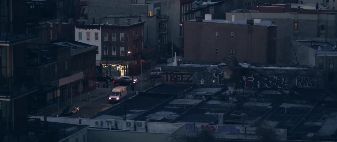 Traffic passes through an intersection in a small town at night