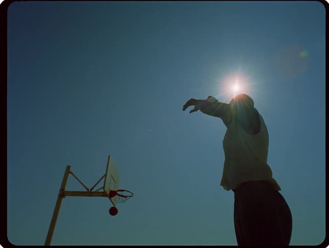 A man shooting a basketball