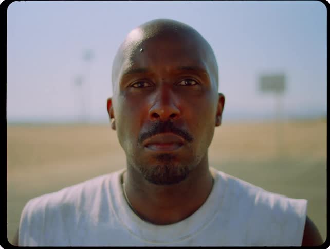 Man stands and stares while on the beach on a summer day