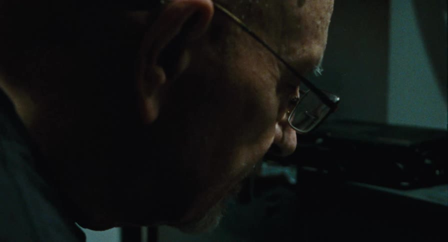 Older man picks up a cassette player